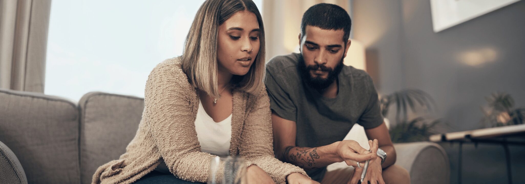 First Time Home Buyers Hero - Couple Looking at Documents Together
